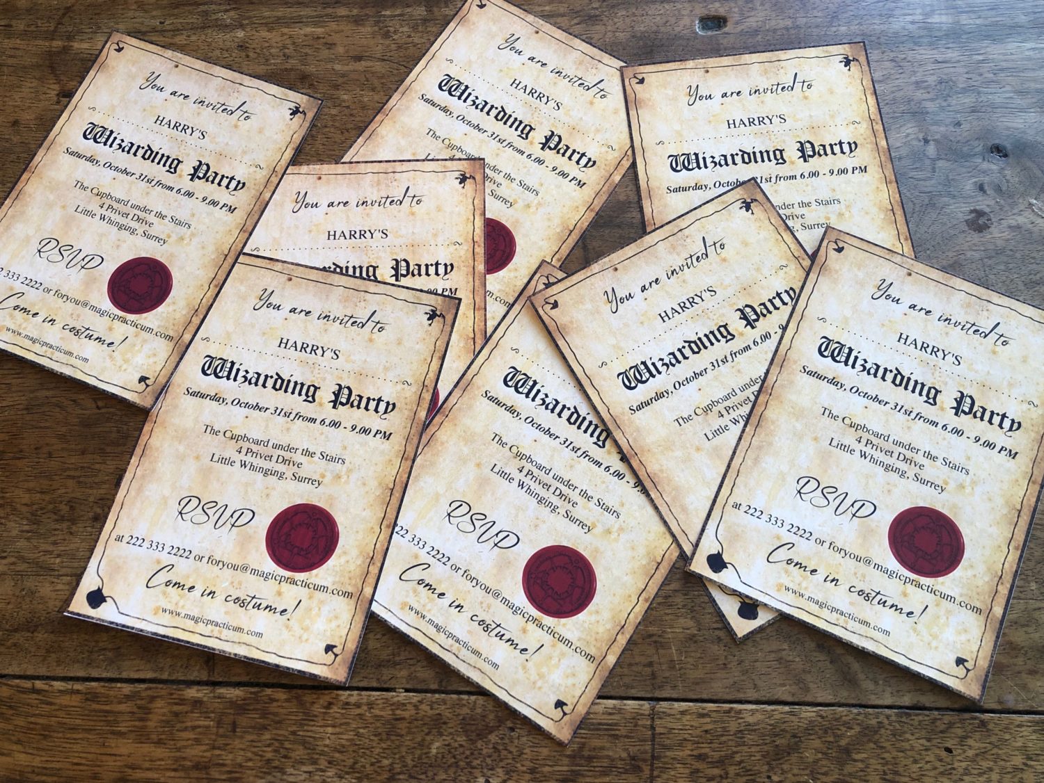 many vintage looking Harry Potter party invitations on the old table