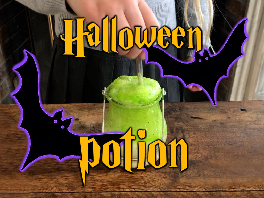 a hand with a spoon mixing green potion Halloween activity